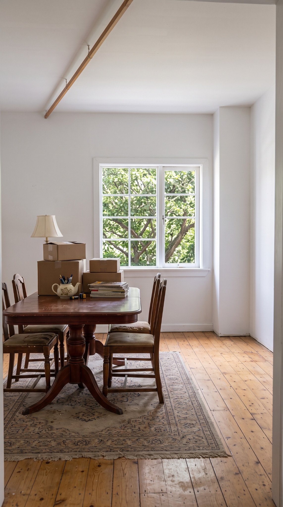 The supplied dining-room reference with a table, boxes and a bright window